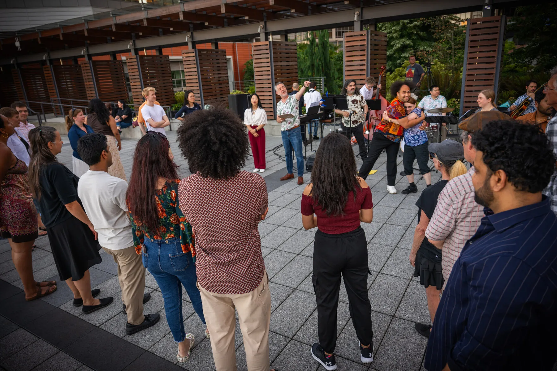 A crowd gathered around the band on the Bellevue City Hall plaza at the 2026 free jazz and swing dance series.