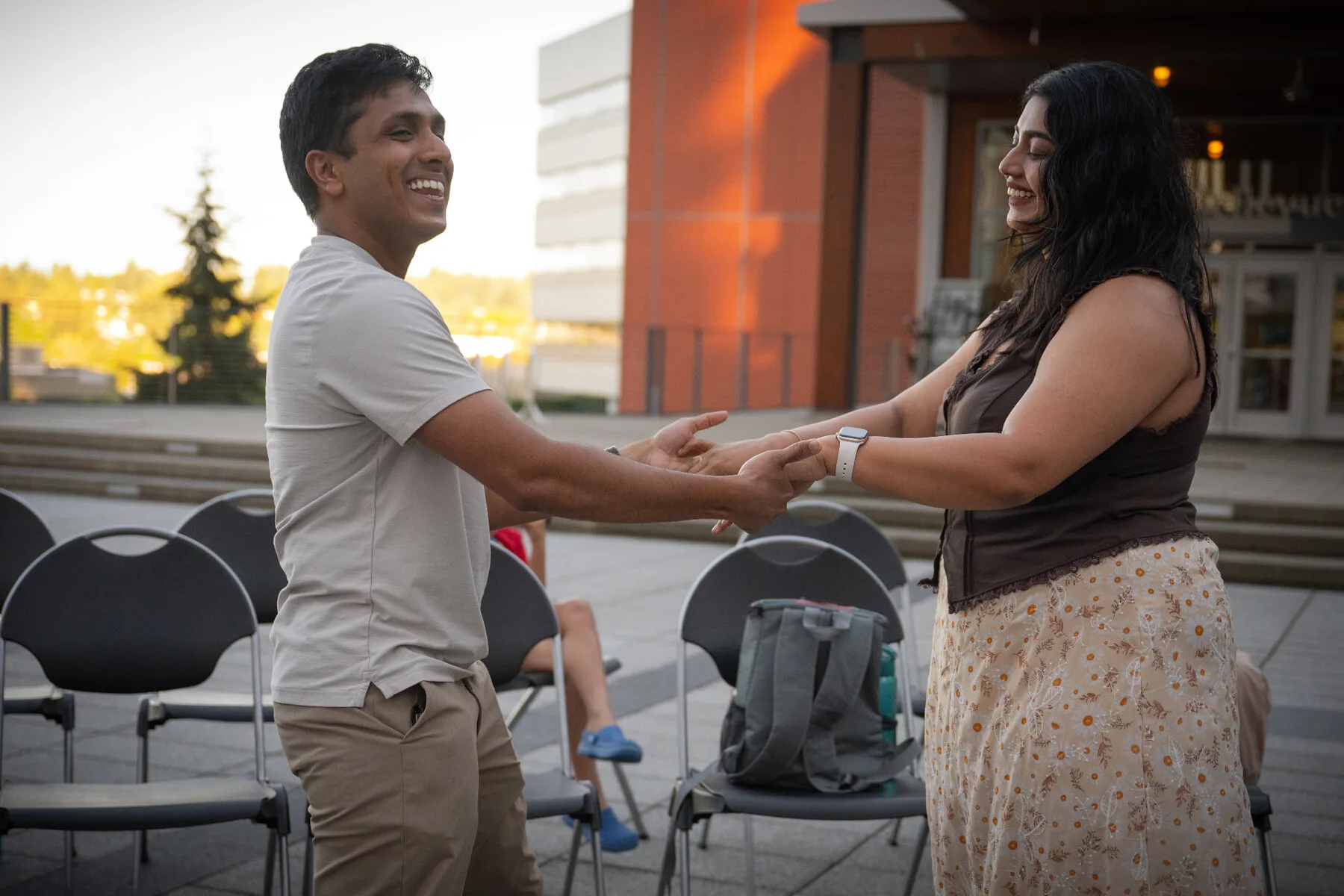 Two dancers smiling at each other and holding hands at the 2026 Bellevue City Hall event.