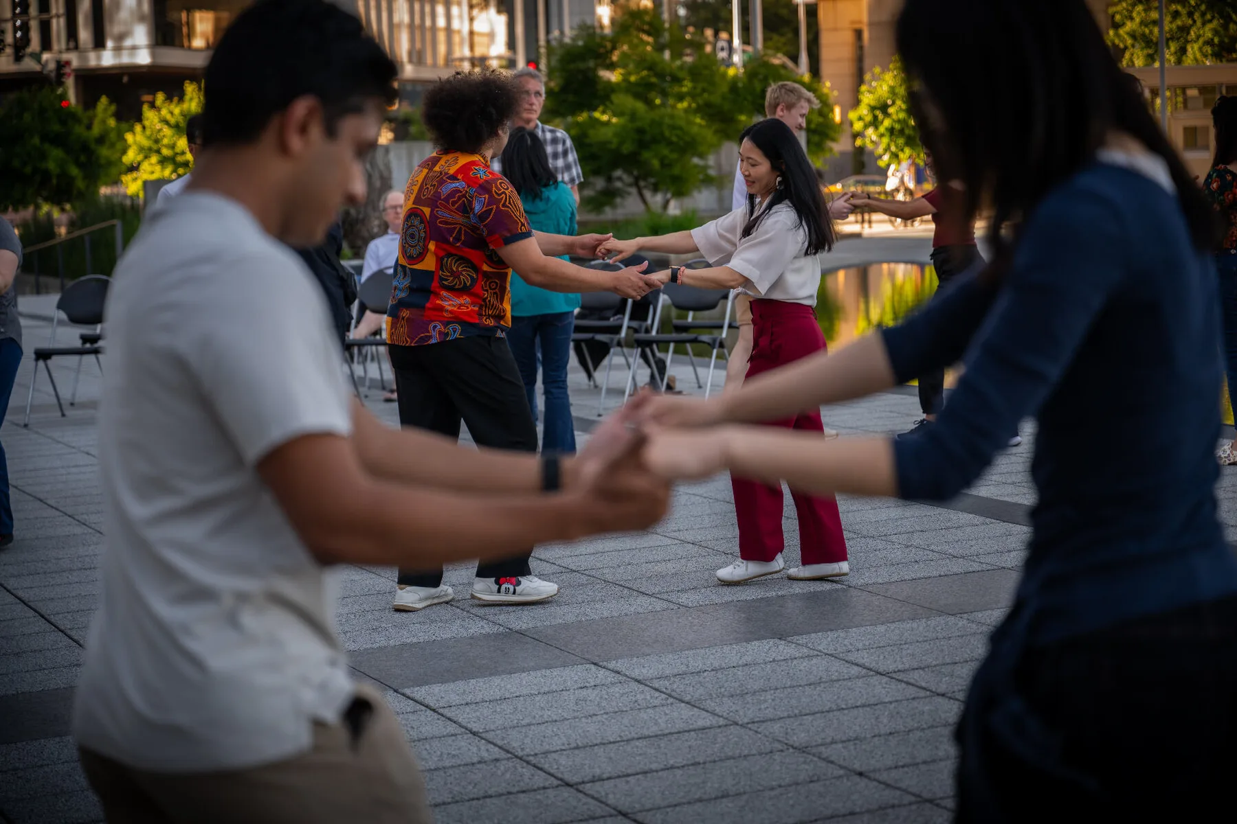 New dancers practicing in a circle on the plaza during the free intro lesson at the 2026 Bellevue event.