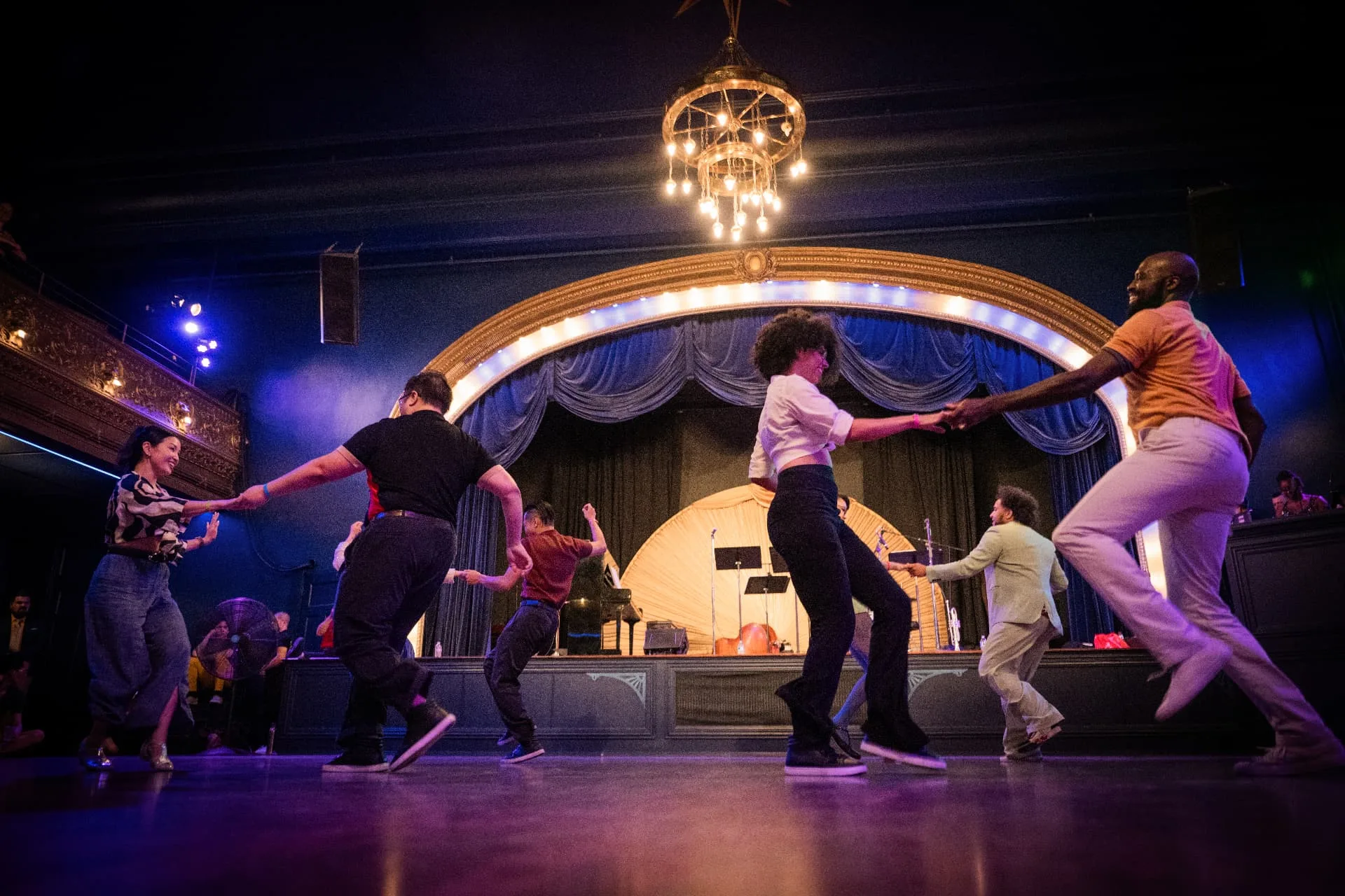 The Swing Arts Foundation performance group dancing in front of the stage at Camp Jitterbug, 2026